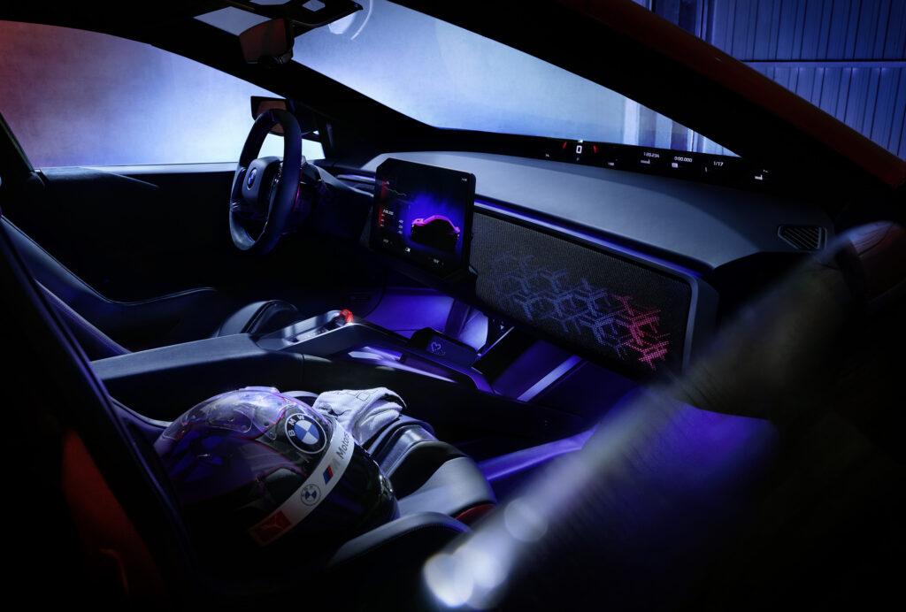 Interior del BMW M Concept Neue Klasse con cabina enfocada en el conductor, tablero flotante, iluminación específica M y detalles inspirados en el automovilismo deportivo.